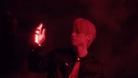a young man holding a glowing object in his hand