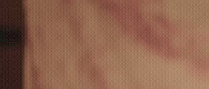 a blurry image of a person's hand holding a cell phone