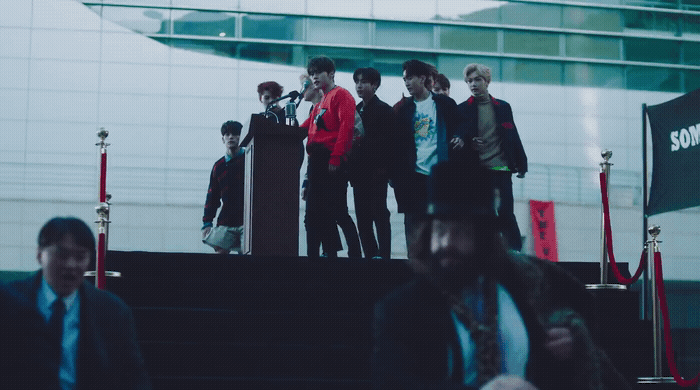 a group of young men standing on top of a stage