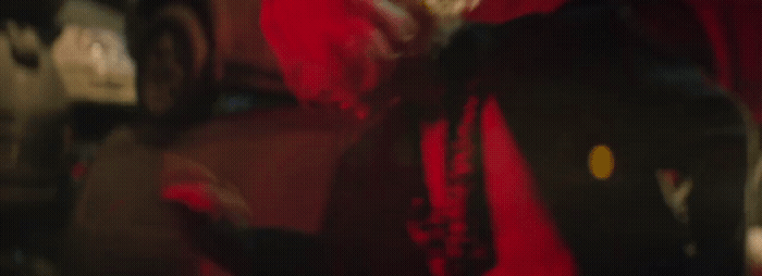 a blurry photo of a man in a red shirt