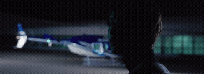 a person standing in front of a helicopter