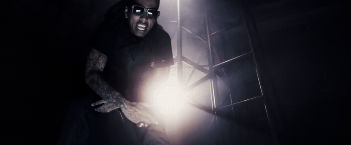 a man holding a flashlight in a dark room