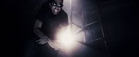a man holding a flashlight in a dark room