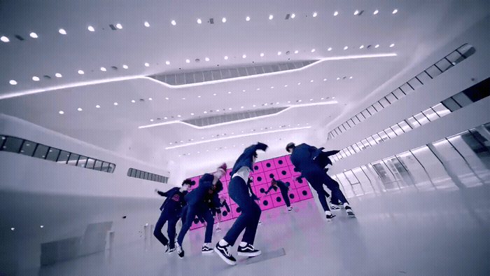 a group of young men riding skateboards in a building