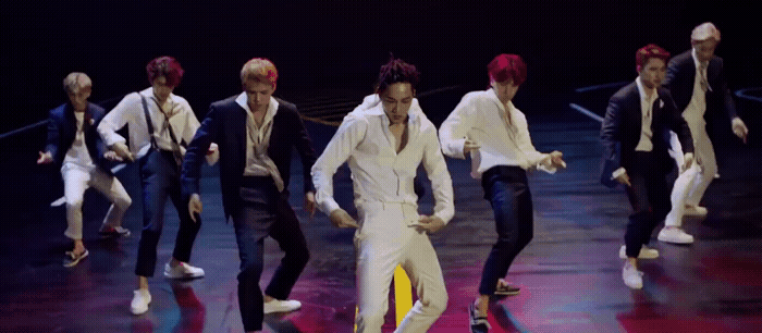 a group of men in suits and ties on a stage