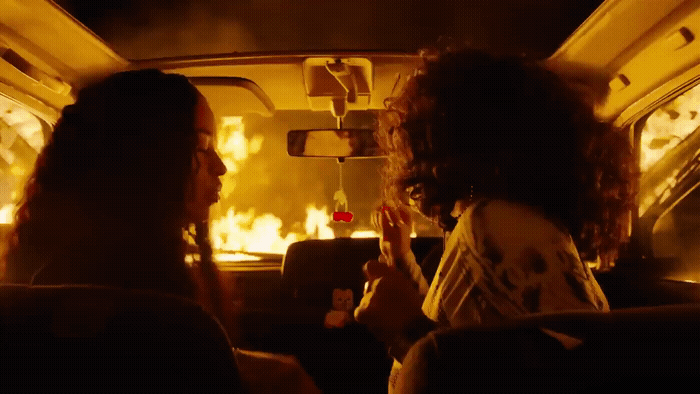 a couple of women sitting in the back of a car