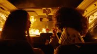 a couple of women sitting in the back of a car