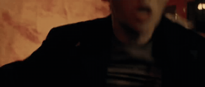 a blurry image of a man in a dark room