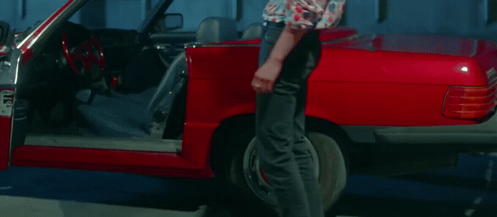 a man standing in front of a red truck