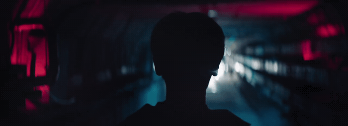 a silhouette of a person in a dark tunnel