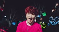 a person with red hair and a pink sweater