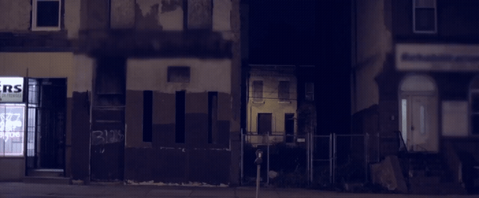 a fire hydrant in front of a run down building