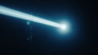 a person standing in the dark holding a flashlight