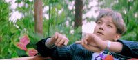 a man in a suit pointing at something