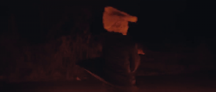 a blurry image of a person holding a skateboard