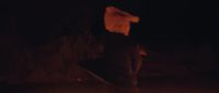a blurry image of a person holding a skateboard