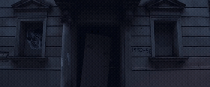an open door to a building with graffiti on it