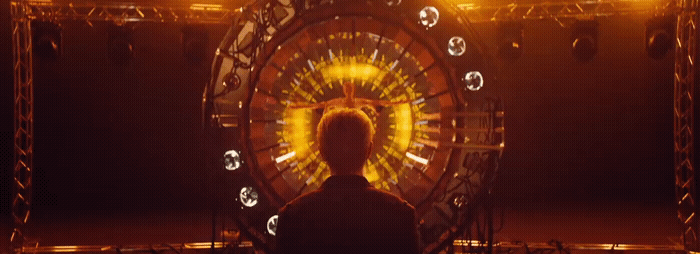 a man standing in front of a ferris wheel