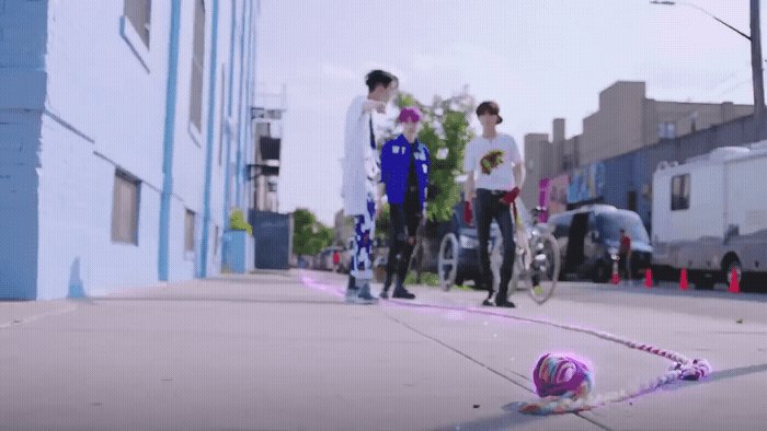 a couple of people standing on a sidewalk