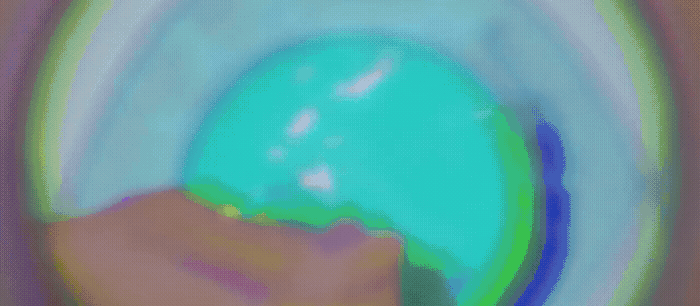 a blurry image of a person holding a green object