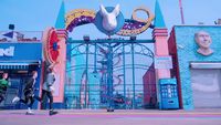 the entrance to a carnival with a giant statue of a bull