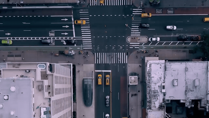 an aerial view of a city street with cars and buses
