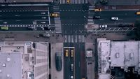 an aerial view of a city street with cars and buses