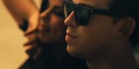 a man wearing sunglasses looking off into the distance