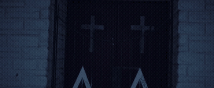 a door with two crosses on it in the dark