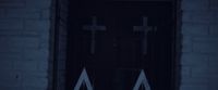 a door with two crosses on it in the dark
