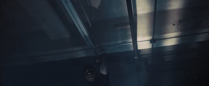 a person standing in a dark room with a light shining on them