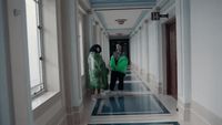 a couple of people that are standing in a hallway