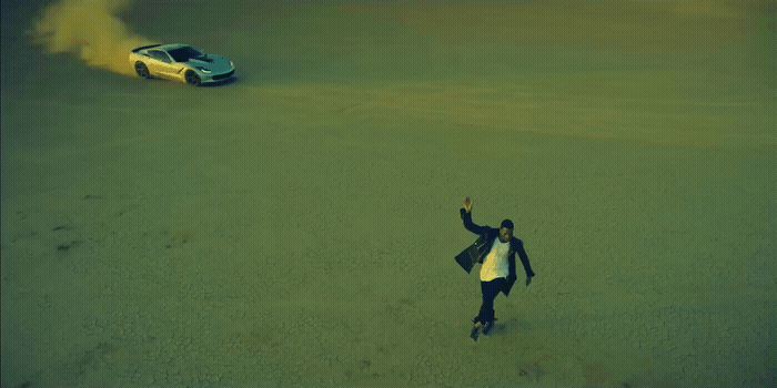 a person standing in the middle of a field next to a car