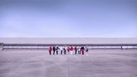 a group of people standing in a parking lot