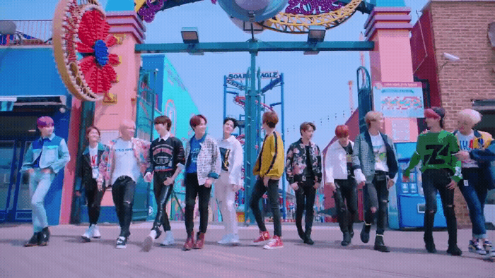 a group of young men standing in front of a sign