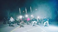 a group of people standing on a street at night