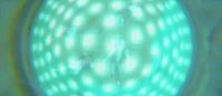 a close up of a green object with white circles