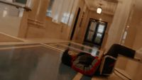 a person laying on the ground in a hallway