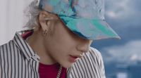 a person wearing a hat and a striped shirt