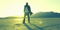 a man standing in the middle of a desert