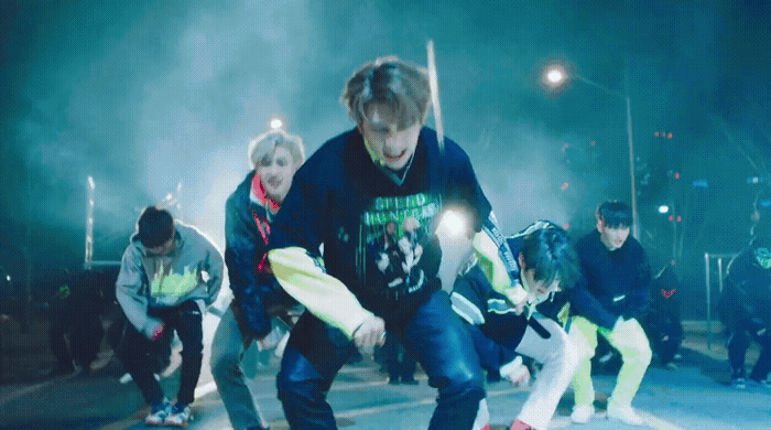 a group of young men riding skateboards down a street