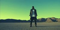 a man standing in the middle of a desert