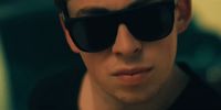 a man wearing sunglasses and a black shirt