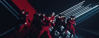 a group of men in red outfits standing on a stage