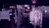 a man standing in a room with a drawing on the wall