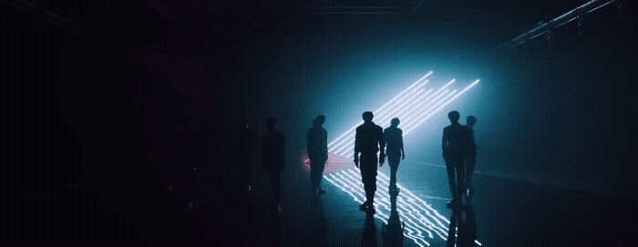 a group of people standing in a dark room