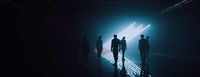 a group of people standing in a dark room