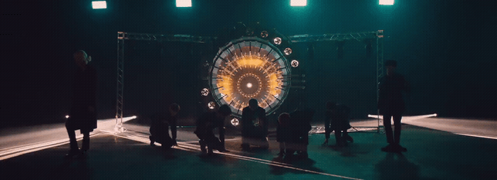 a group of people standing in front of a stage