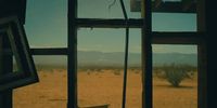 a window with a view of the desert outside