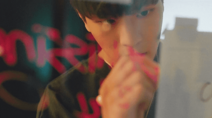 a young man looking at his reflection in a mirror